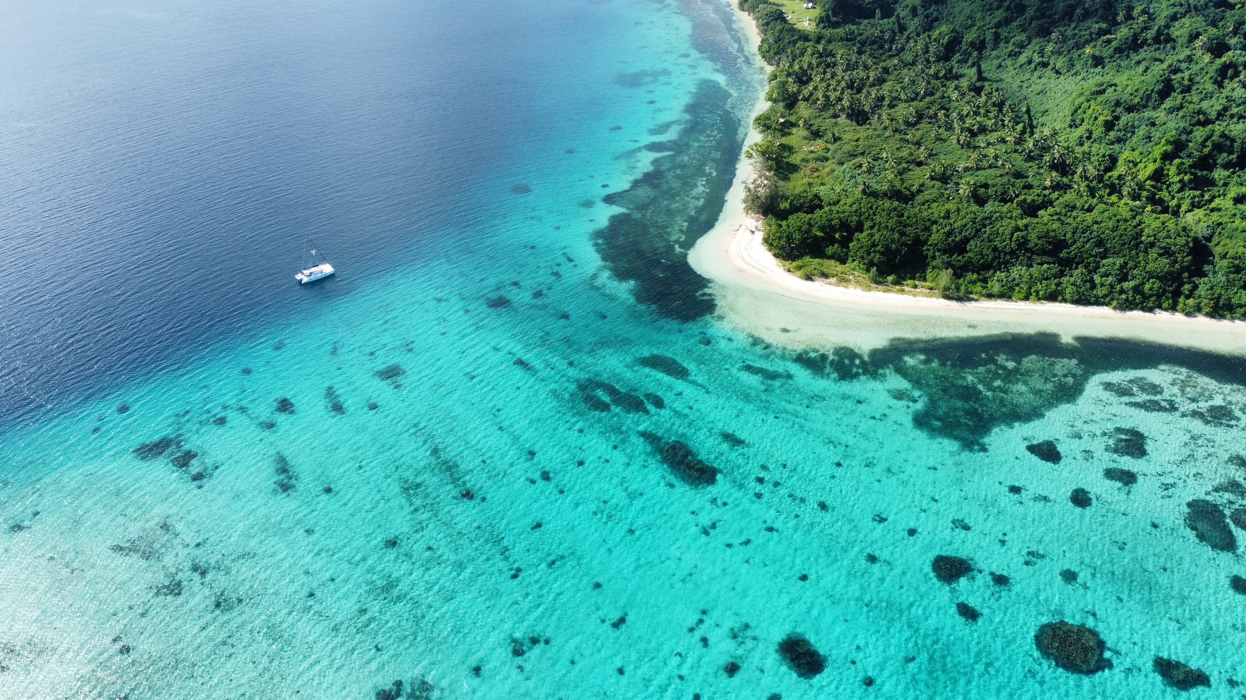 Aerial view of an island in clear water