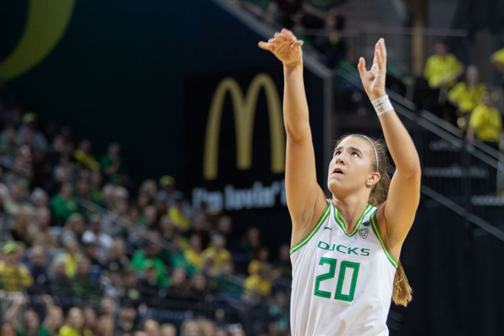 Sabrina Ionescu shoots a basket while on the UO Women's Baskeball team in front of a full arena