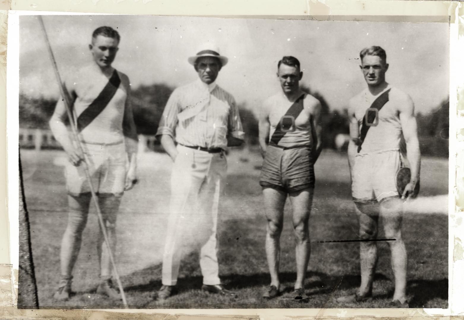 Bill Hayward and three students standing outside posing for the camera.