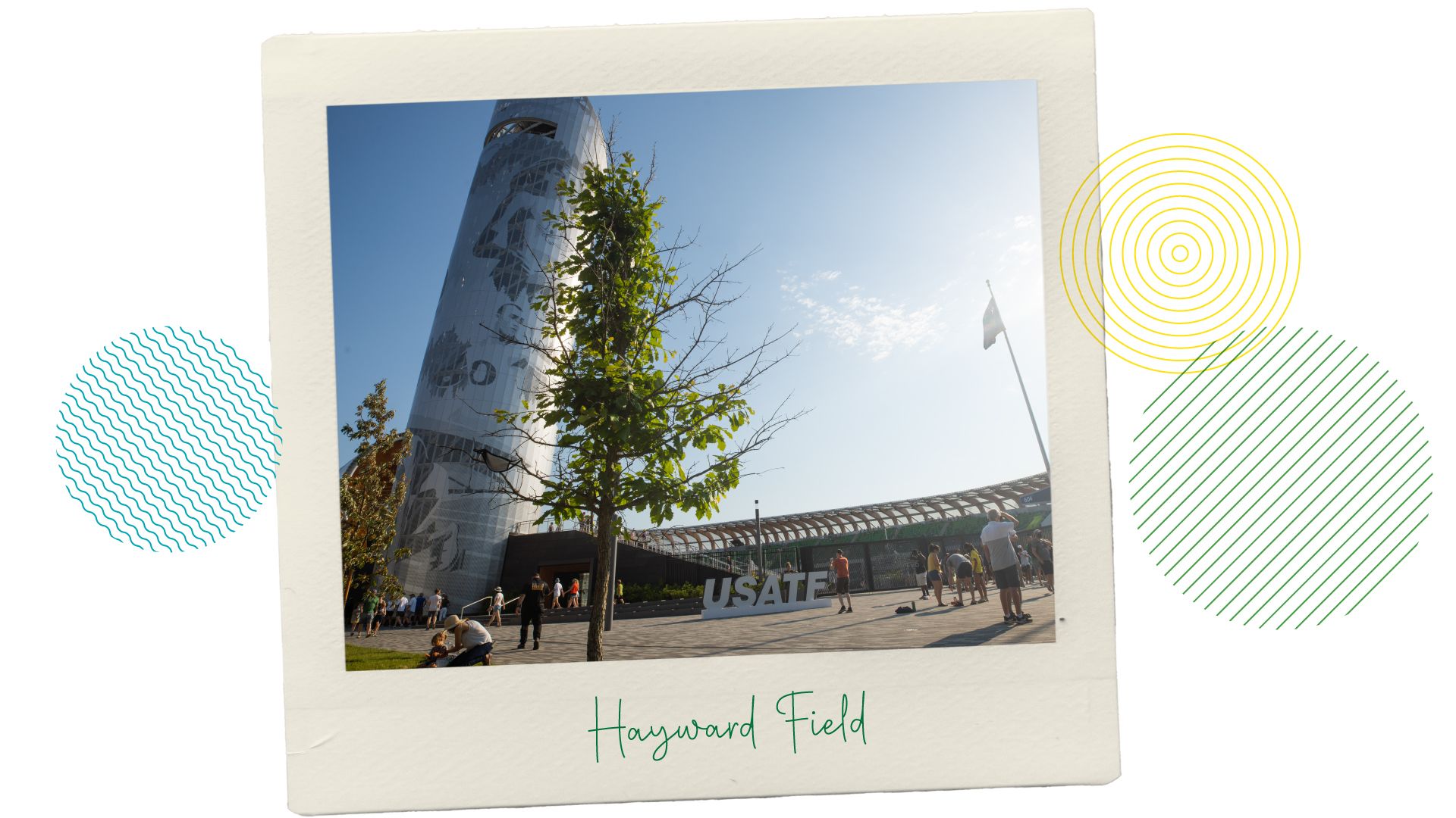 The exterior of Hayward Field and tower on a sunny day with people walking around.