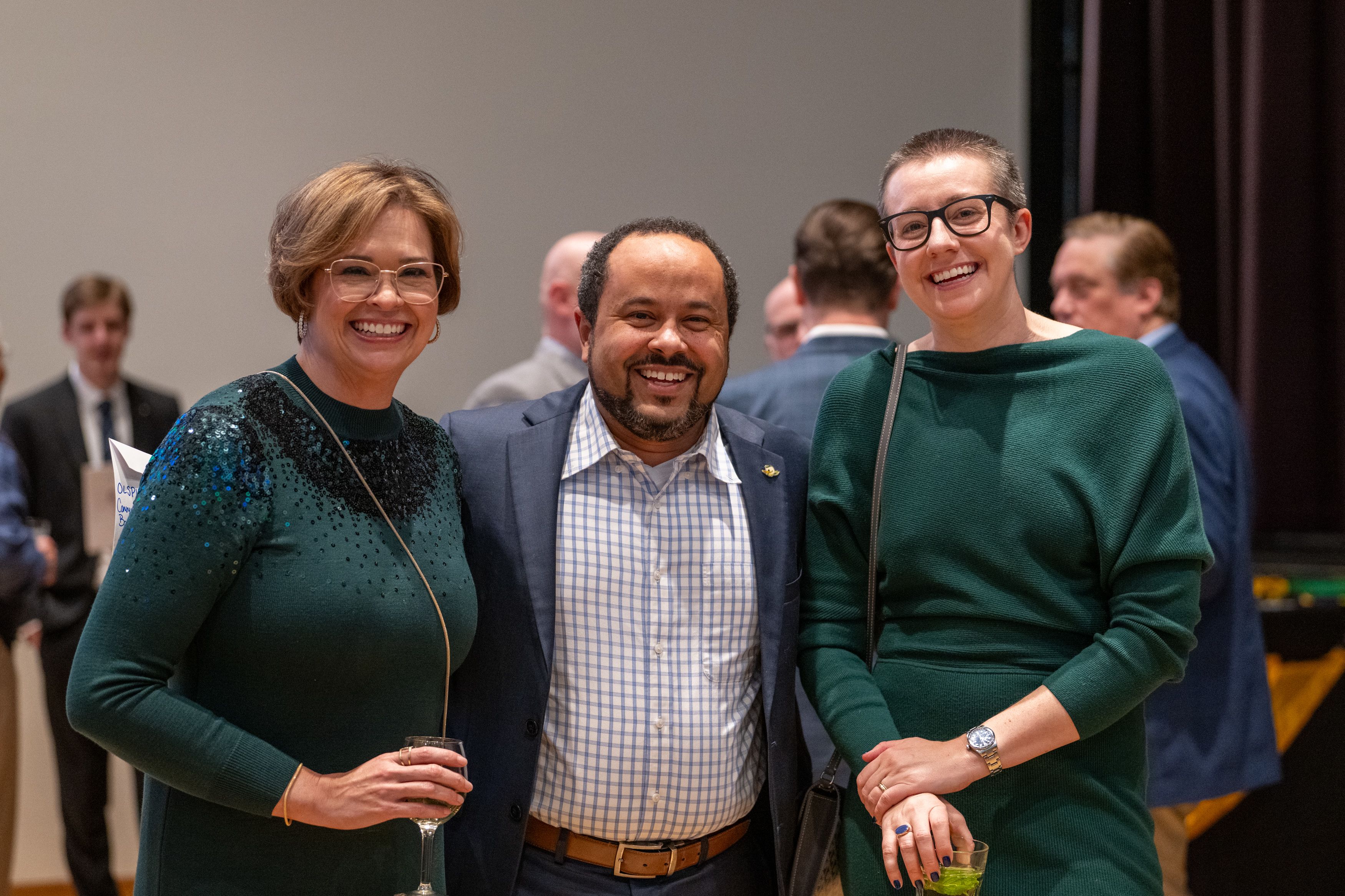 Dean Jennifer Espinola, staffer Noah Glusman and a guest smile at the camera.