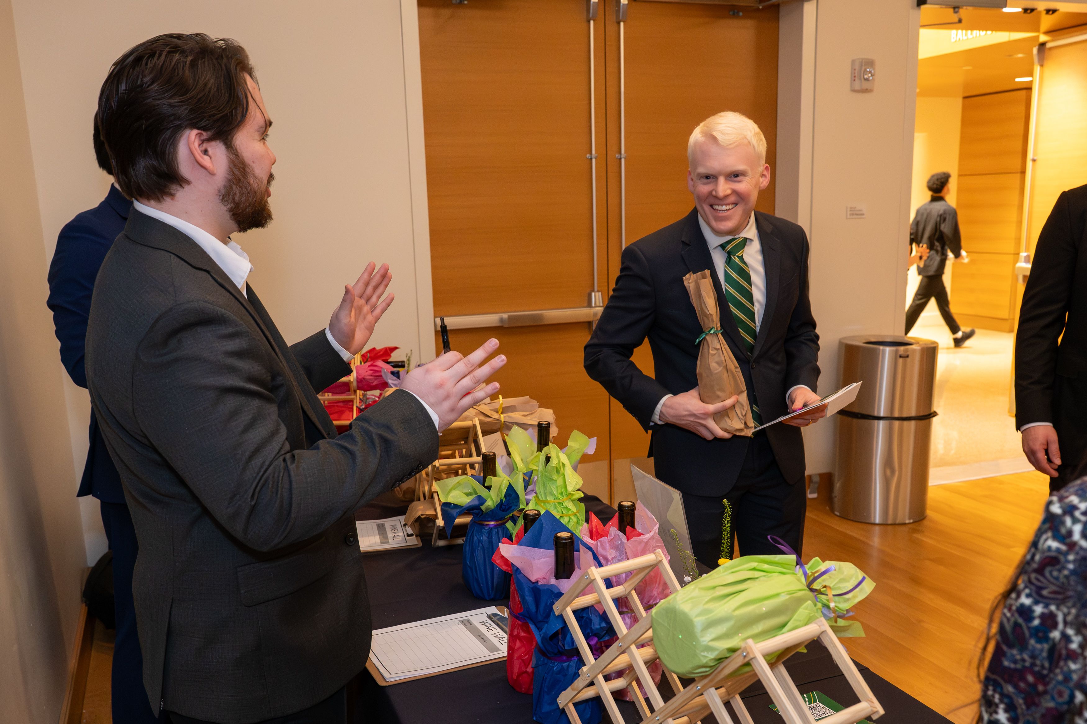 Guest buying a pull from the wine wall. 