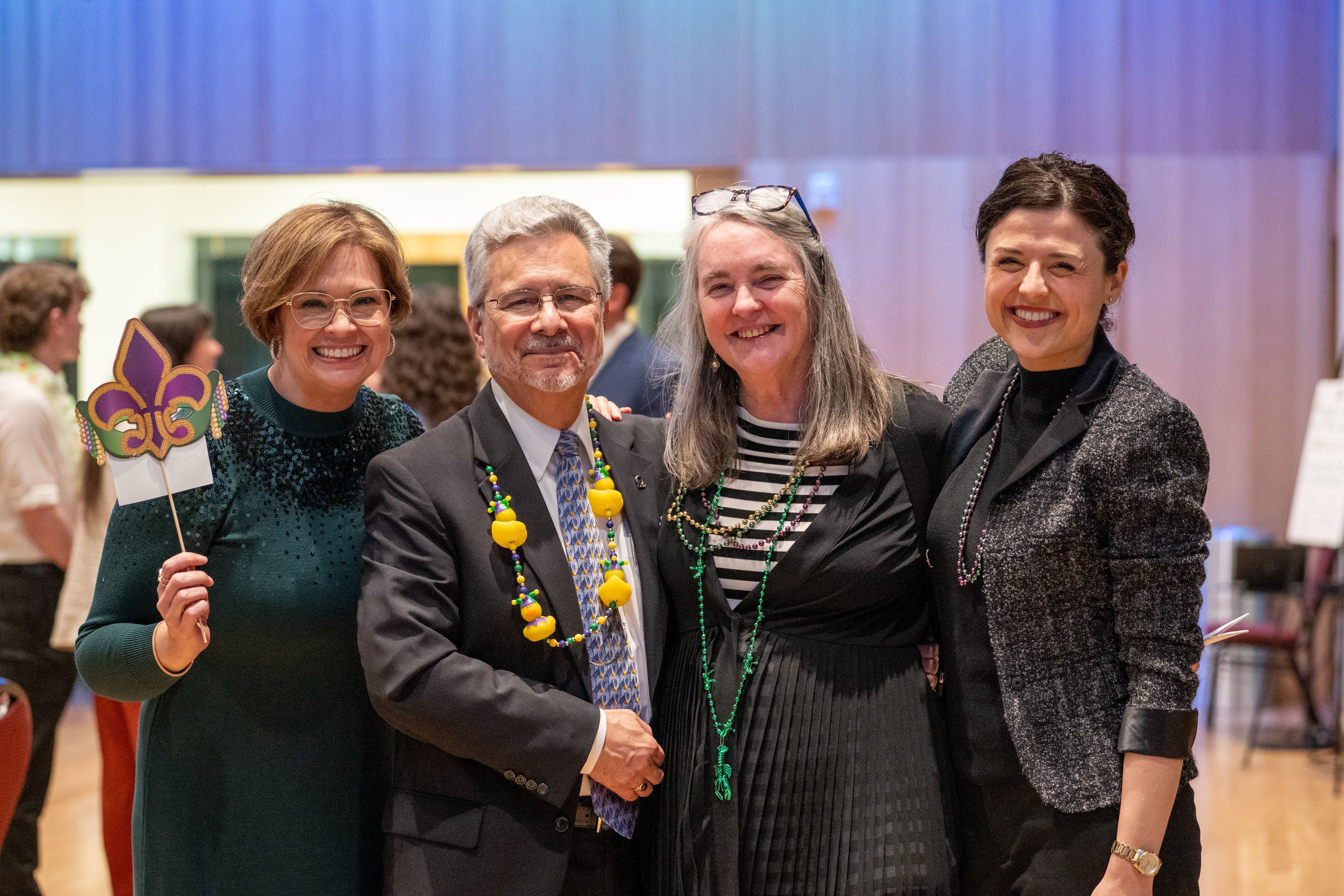 Jennifer Espinola, Judge Acosta, Lenice Shaw and Andrea Welsh pose for the camera with Mardi Gras props. 