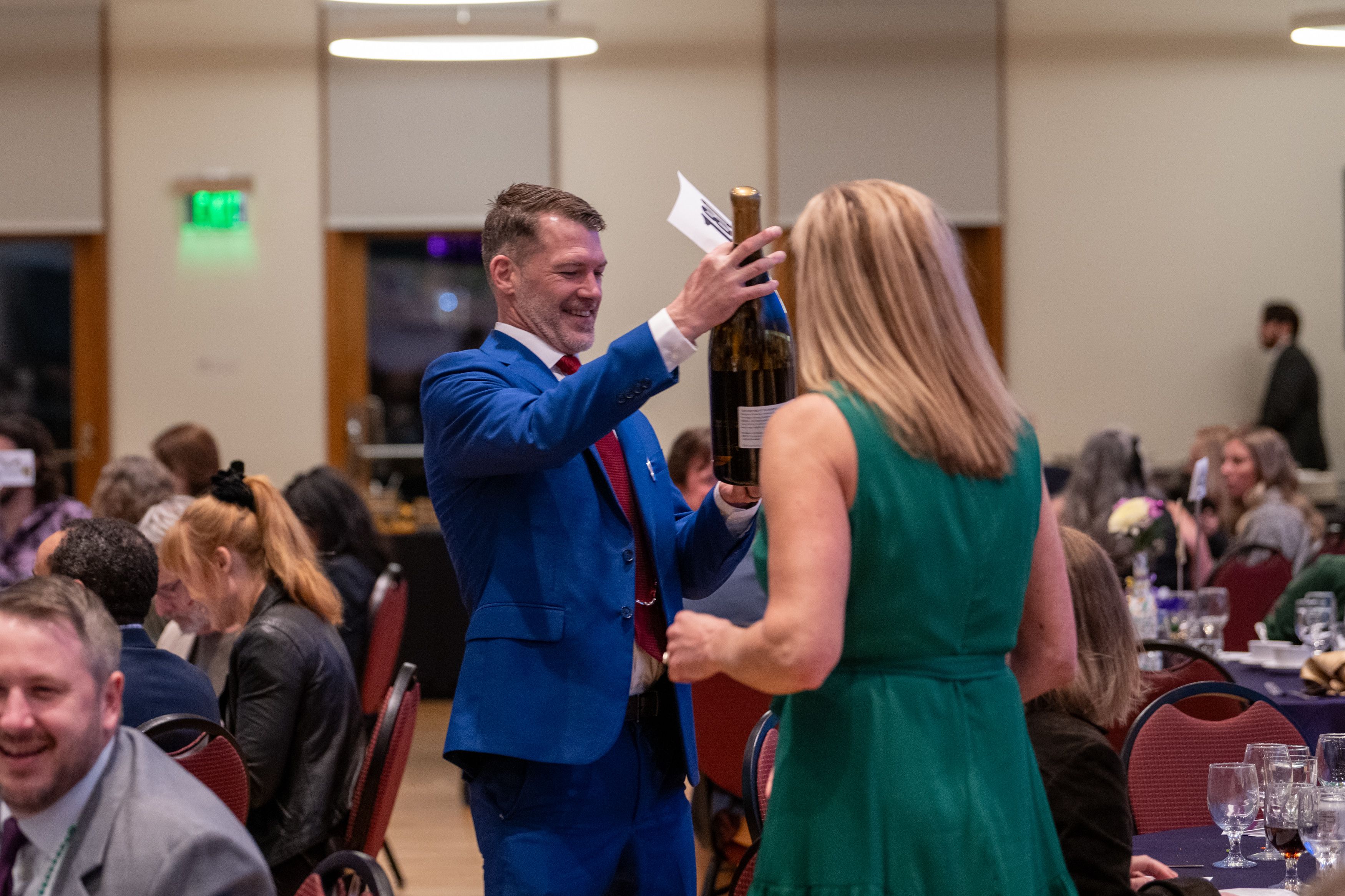 Man looks at a double magnum of King Estate Wine.