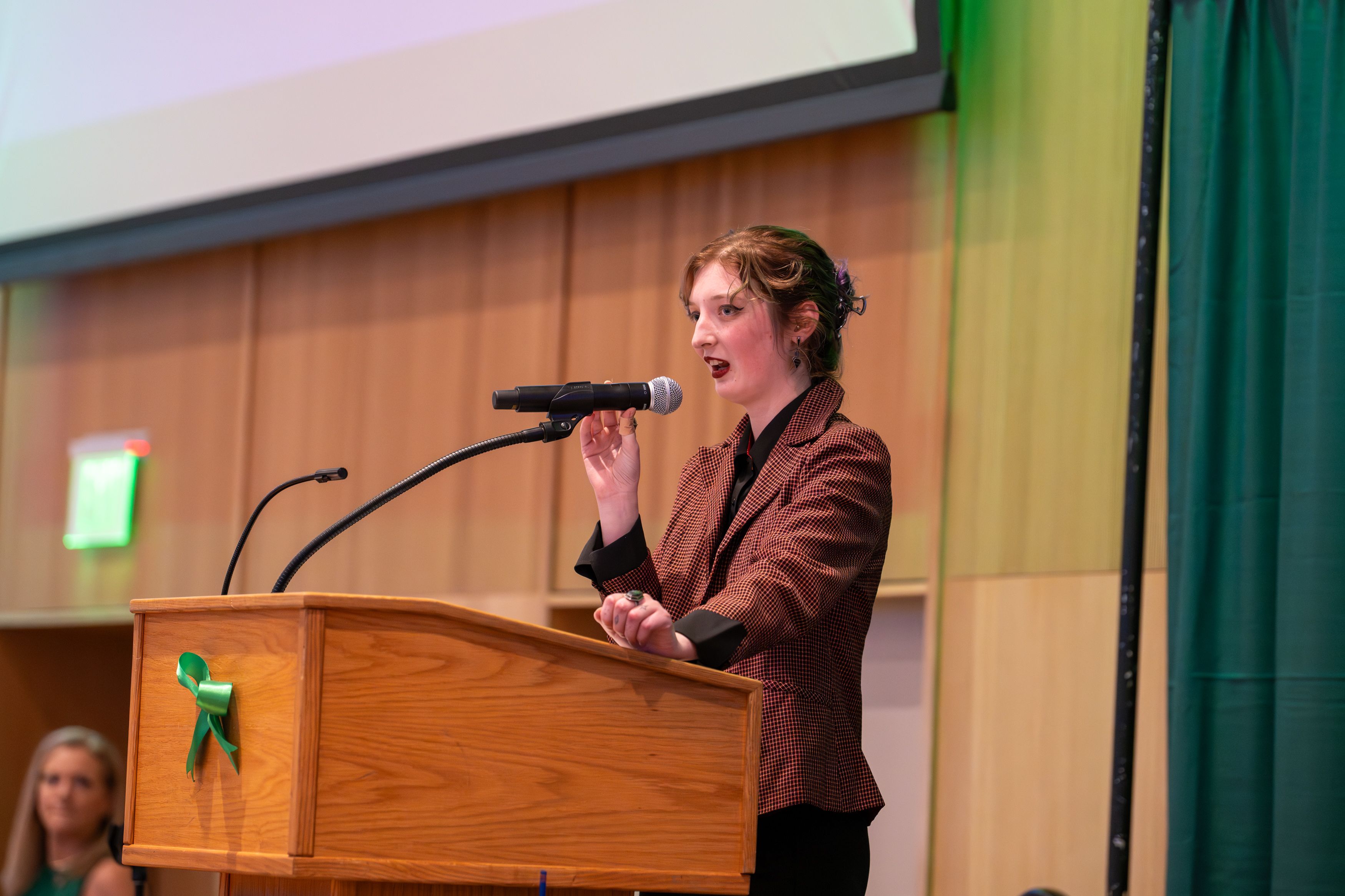 Stipend recipient  Helen Ingram Tuttle speaking at a microphone.