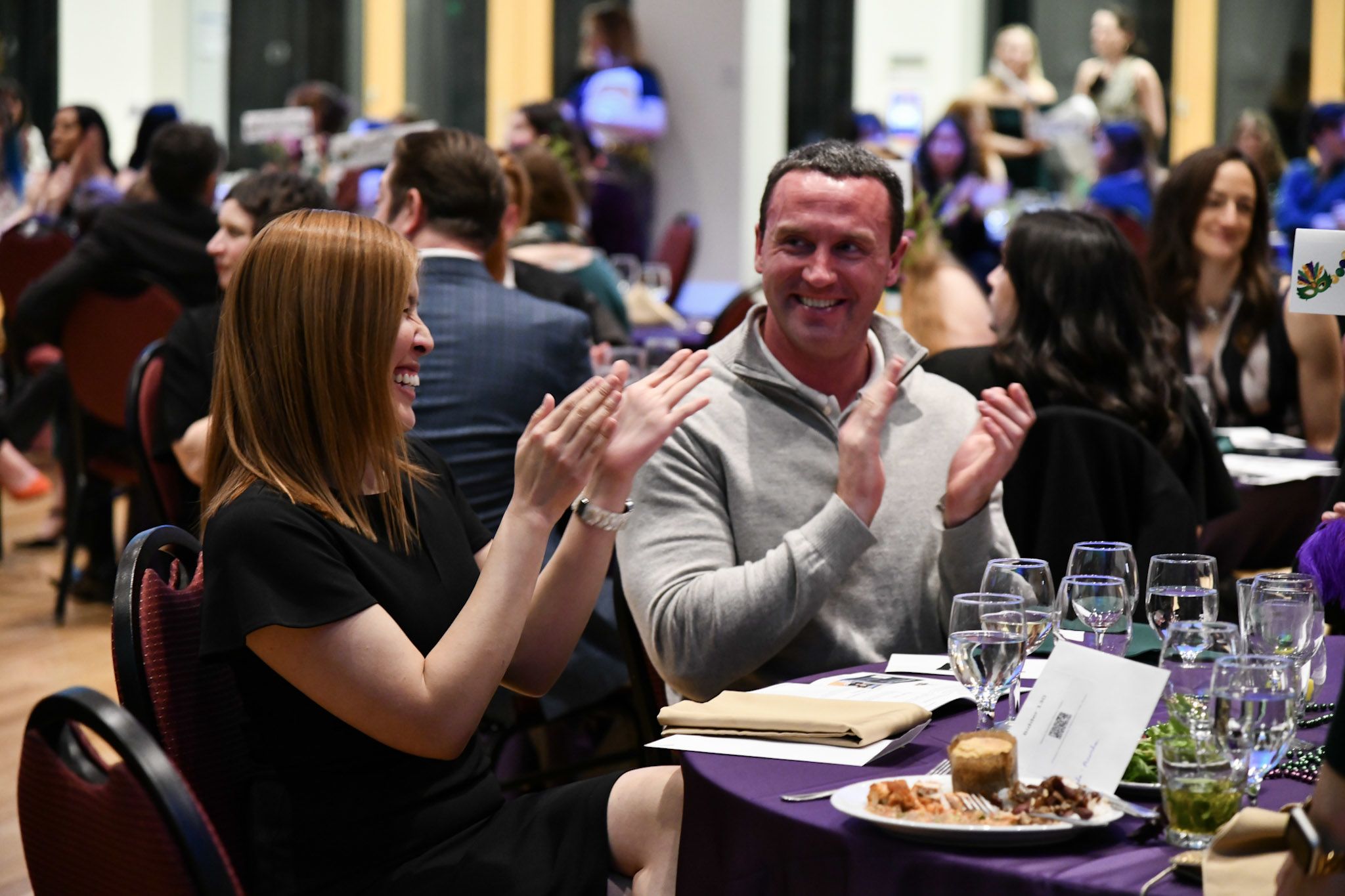 Victoria Nguyen and Anthony Button clapping. 