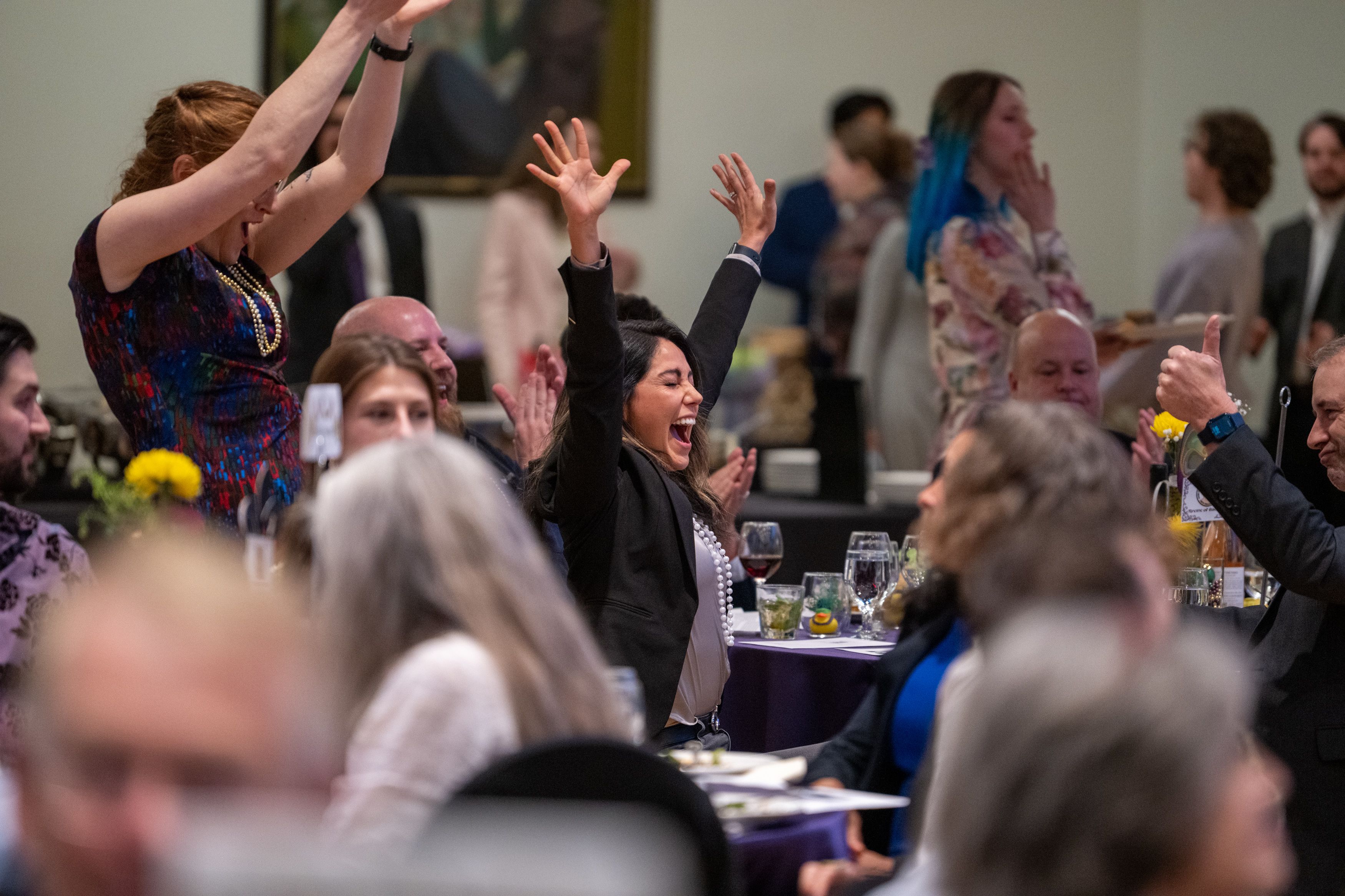 Guest jumping with joy after winning an auction item. 