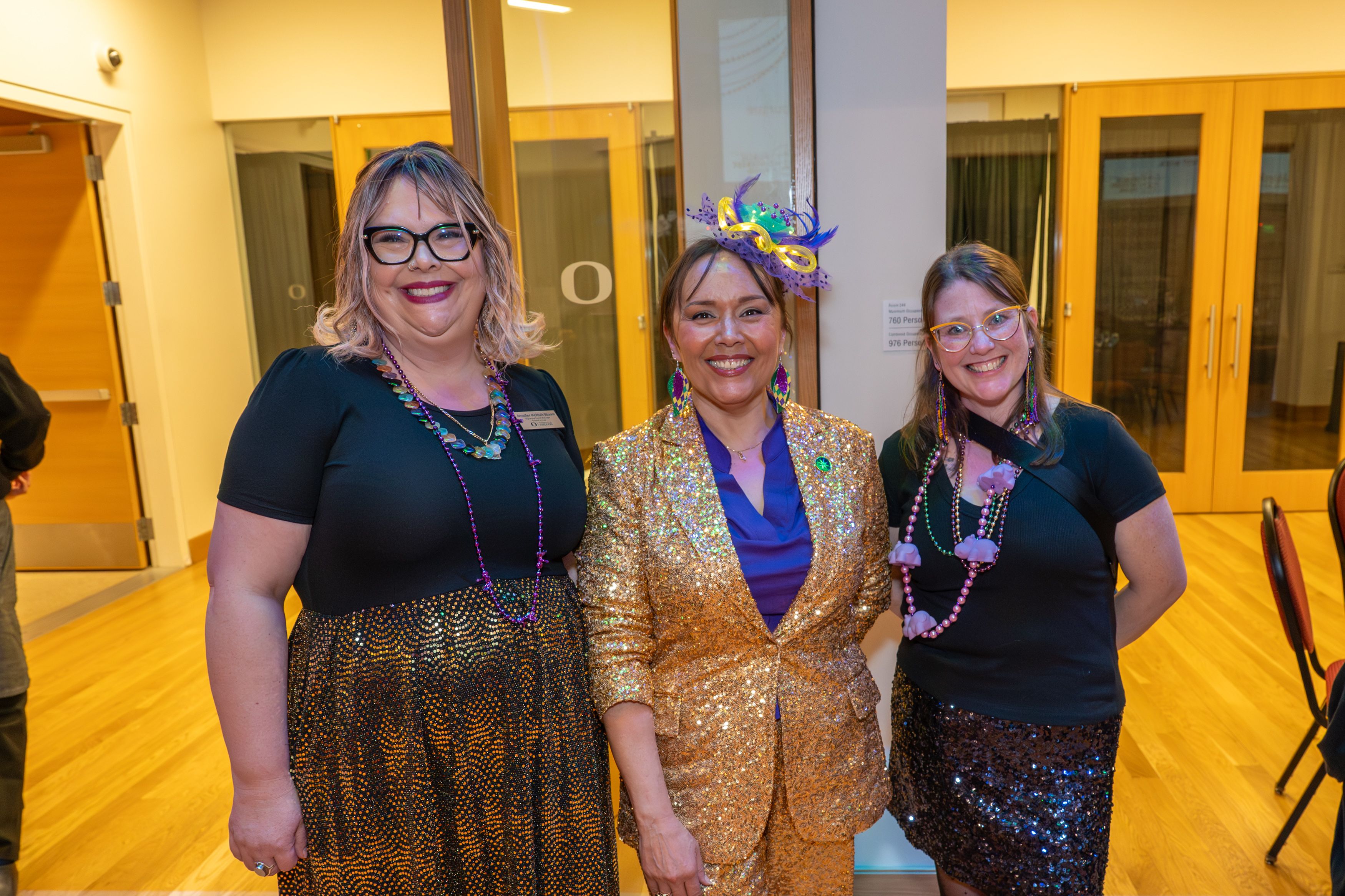 Staff members Jen McNutt-Bloom and Cara Olson pose with the auctioneer Misty Marquam. 