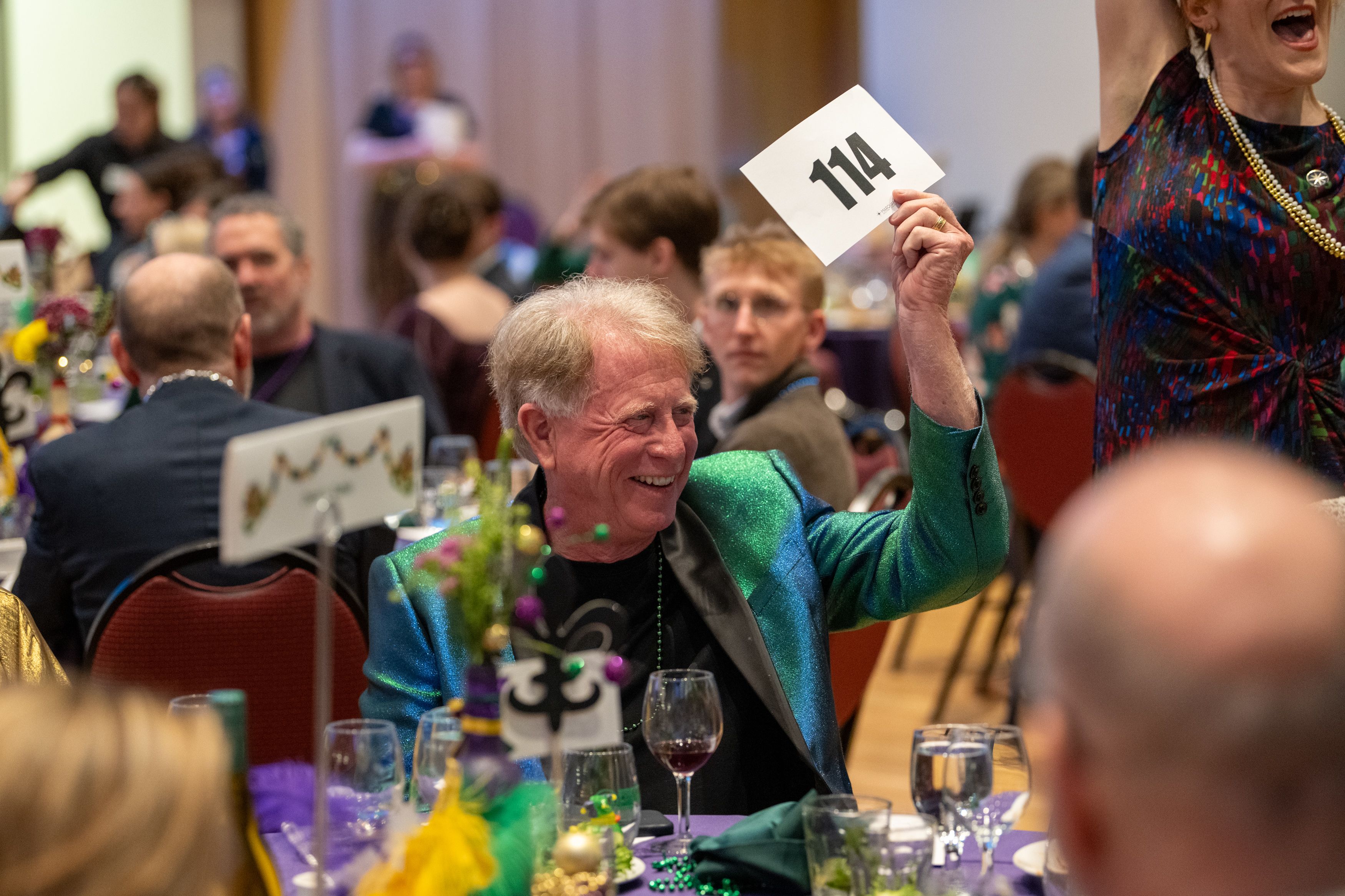 Mike Axeline raises his paddle to give money to OLSPIF.